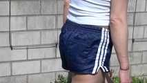 Sexy Sandra wearing a sexy darkblue shiny nylon shorts and a blue downvest during her gardening work (Video)