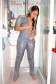 Stella wearing a supersexy grey rainwear catsuit under the shower (Pics)