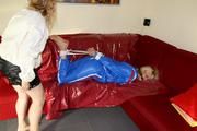 Pia tied and gagged by Sophie on the sofa wearing a shiny blue PVC sauna suit (Pics)