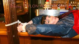 An archive girl tied and gagged on a bar wearing shiny nylon rainwear (Pics)