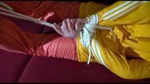 Lucy tied, gagged and hooded on a red sofa wearing a sexy orange shiny nylon pants and a yellow rain jacket (Video)