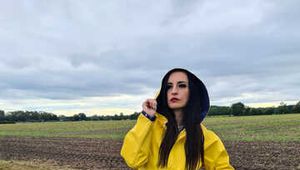 Miss Amira on the road in a Frisian mink, yellow rain dungarees and rubber boots
