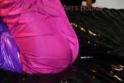 Pia wearing a pink rain pants and a purple down jacket tied with cuffs and gagged on bed (Pics) 