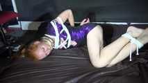 Red haired Woman bound and gagged in a shiny purple wetlook Dress