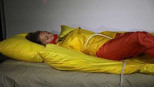 Sexy Sandra tied and gagged with ropes and a clothgag wearing a supershiny orange shiny nylon pants and a yellow rain jacket (Pics)