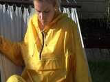 Watch Chloe enjoying the warm Sun in her yellow shiny nylon Rainsuit 