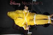 Sandra being tied and gagged on a hairdresser´s chair wearing sexy yellow shiny nylon rainwear being double hooded (Pics)