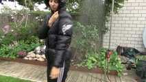 Watching Aiyana wearing a sexy black shiny nylon rainpant and a black shiny nylon down jacket trying the garden shower  (Video)