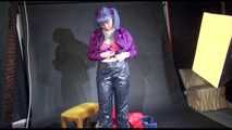 Mara wearing sexy purple rainwear trying on a black down pants and a red down jacket infront of the camera (Video)