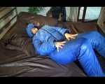 Jill putting on a sexy blue shiny nylon down suit and lolling on bed (Pics)