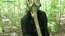 in the forest with a dress and a gas mask