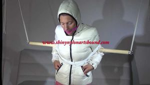 Sexy Sandra tied, gagged and hooded with ropes, a bar  and a ballgag wearing a supershiny rose shiny nylon pants and a white special down jacket (Video)