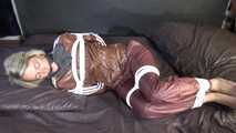 Watching sexy Sonja being tied and gagged on a bed with ropes and a clothgag wearing a supersexy shiny brown nylon pants and a brown rain jacket (Video)