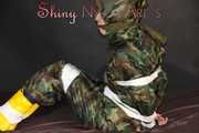 Sexy PIA being tied and gagged with tape and a clothgag on the sofa wearing a camouflage rainsuit and yellow rubber boots (Pics)