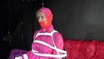 Watching sexy Pia being tied and gagged with ropes and a clothgag on a hairdressers chair wearing a very sexy pink rainwear combination with hood (Video)