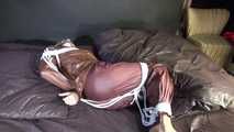 Watching sexy Sonja being tied and gagged on a bed with ropes and a clothgag wearing a supersexy shiny brown nylon pants and a brown rain jacket (Video)