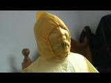 Jill tied and gagged on a chair wearing a yellow rainsuit and coveres with an yellow raincoat with two hoods (Video)