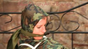 Pia tied, gagged and hooded in a princess bed wearing a sexy shiny camouflage rainwear (Pics)