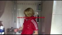 Sonja tied and gagged in a shower cabine with cuffs wearing a supersexy red shiny nylon jumpsuit (Video)