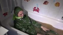 Mara ties, gagges and hoodes herself in a bath tub with muddy water wearing a sexy rainwear jumpsuit with hood (Video)