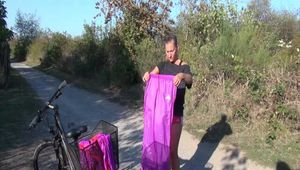 Watch Sandra riding her Bike in her sexy pink shiny nylon Rainsuit