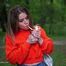 Pretty Kate is smoking Marlboro Red 100s in the park