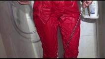 Sonja tied and gagged in a shower cabine with cuffs wearing a supersexy red shiny nylon jumpsuit (Video)