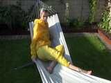 Watch Chloe enjoying the warm Sun in her yellow shiny nylon Rainsuit 