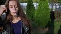 Irina is smoking on the street