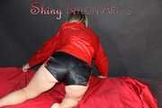 Watching sexy SONJA wearing a sexy black shiny nylon shorts and a red rainjacket preparing her lolling area (Pics)