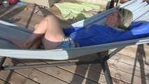 SEXY Sonja wearing sexy shiny nylon shorts enjoying the sun and the shorts in a hammock (Video)