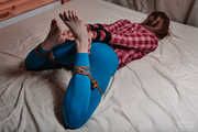 Tied arms and legs in blue leggings and blouse