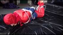 SANDRA tied, gagged and hooded on the floor wearing a supersexy oldschool red/blue down suit (Video)