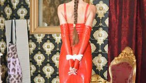 Miss Scarlett bound and gagged in a long red Latex dress