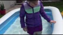 Watching Mara wearing a supersexy purple down skirt and a purple down jacket cleaning the swimming pool and playing with water (Video)