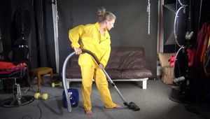 Watching sexy SANDRA vacuum cleaning the studio wearing a sexy yellow rainwear combination (Video)