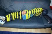 Katharina taped and gagged in a blue nylon rainsuit