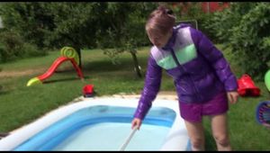 Watching Mara wearing a supersexy purple down skirt and a purple down jacket cleaning the swimming pool and playing with water (Video)