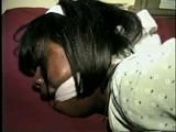 26 YR OLD BLACK BANK TELLER IS HOG-TIED, CLEAVE GAGGED AND HANDGAGGED WHILE STRUGGLING ON THE BED (D52-12)