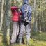 Sebastien breathplay tied up in a puffer jacket among the trees.