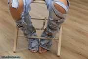 Hot jeans girl cuffed on a chair