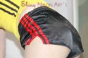 SONJA wearing a supersexy black shiny nylon shorts and a yellow top preparing her bed (Pics)