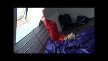 Samantha tied and gagged on bed wearing a shiny red sauna suit (Video)