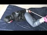 03:10 Min. video with Nina tied and gagged in a shiny nylon down jacket and shiny nylon rainpants