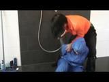 Jill in a shiny blue rainsuit tied,hooded and gagged by Simone under the shower (Video)