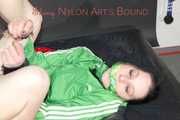 ***HOT HOT HOT*** LUCY tied and gagged on a bed with a bar and a cloth gag wearing sexy green shiny nylon shorts and a green rain jacket (Pics)
