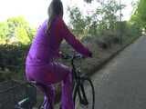 Watch Sandra riding her Bike in her sexy pink shiny nylon Rainsuit