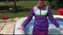 Watching Mara wearing a supersexy purple down skirt and a purple down jacket cleaning the swimming pool and playing with water (Video)