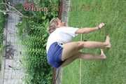 Watching sexy Sandra wearing a oldschool blue shiny shorts and a top while gardening outside (Video)