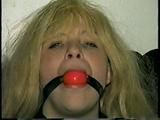 SEXY BOMBSHELL TRACY BALL-GAGS HERSELF, IS MOUTH STUFFED & HANDGAGED (D38-10)